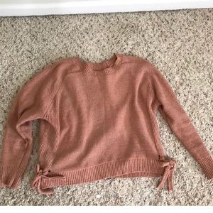 Pink salmon sweater with bows on side